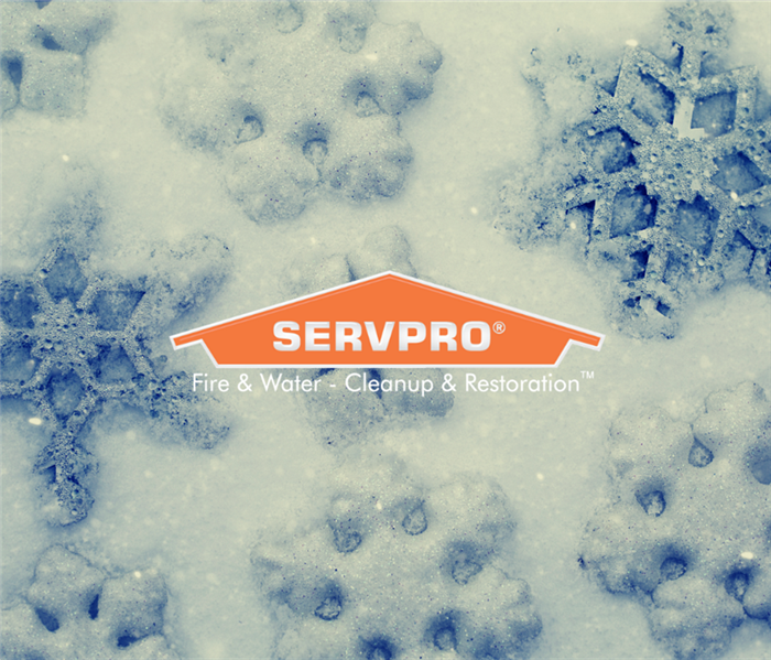 SERVPRO logo with snowflakes in the background.